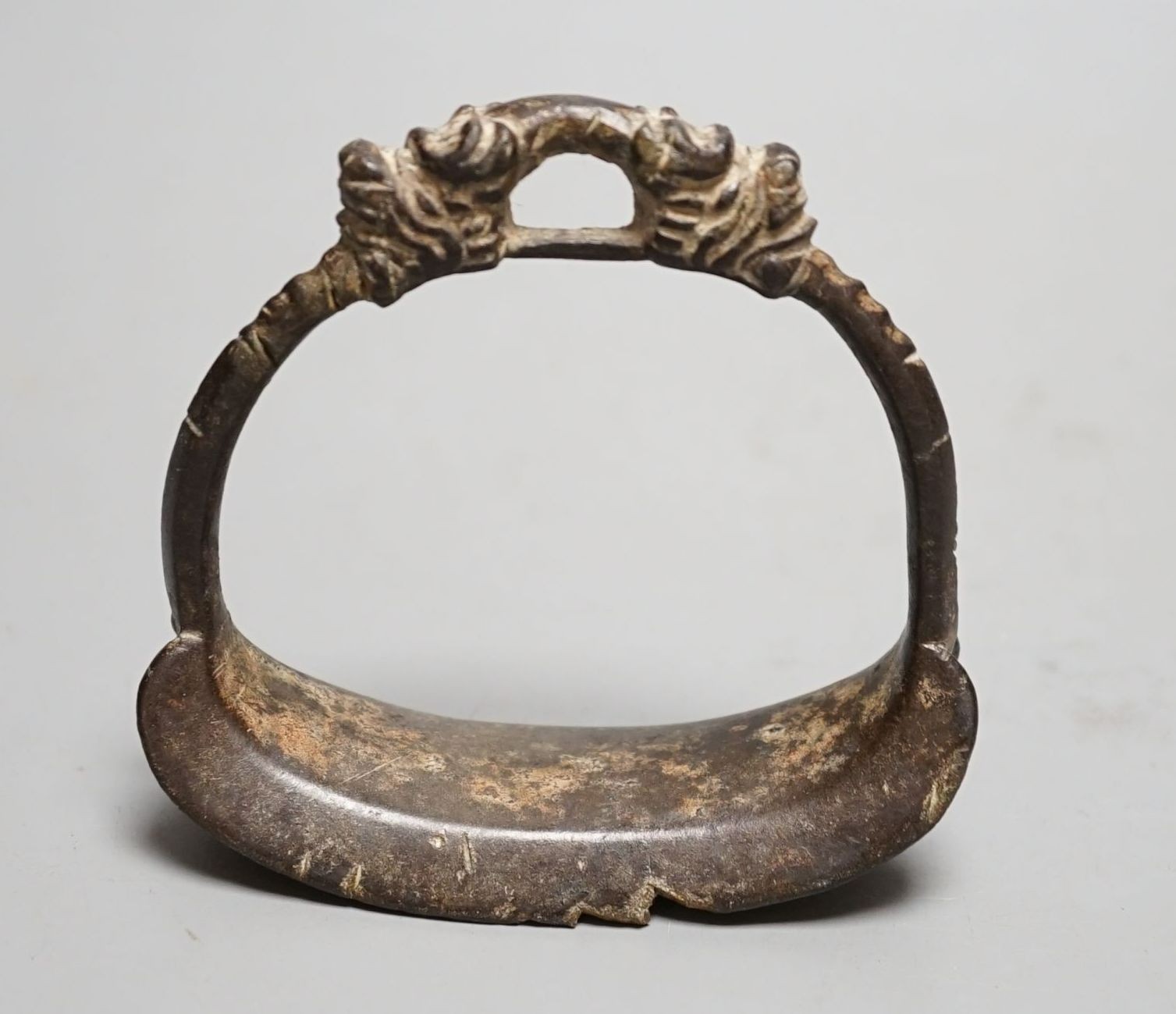 A Chinese archaic (?) bronze stirrup, 10 cms high.